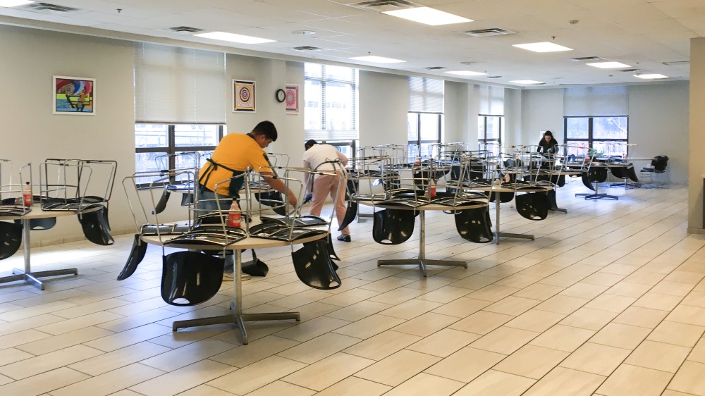 An image of volunteers cleaning up our dining room after the meal time